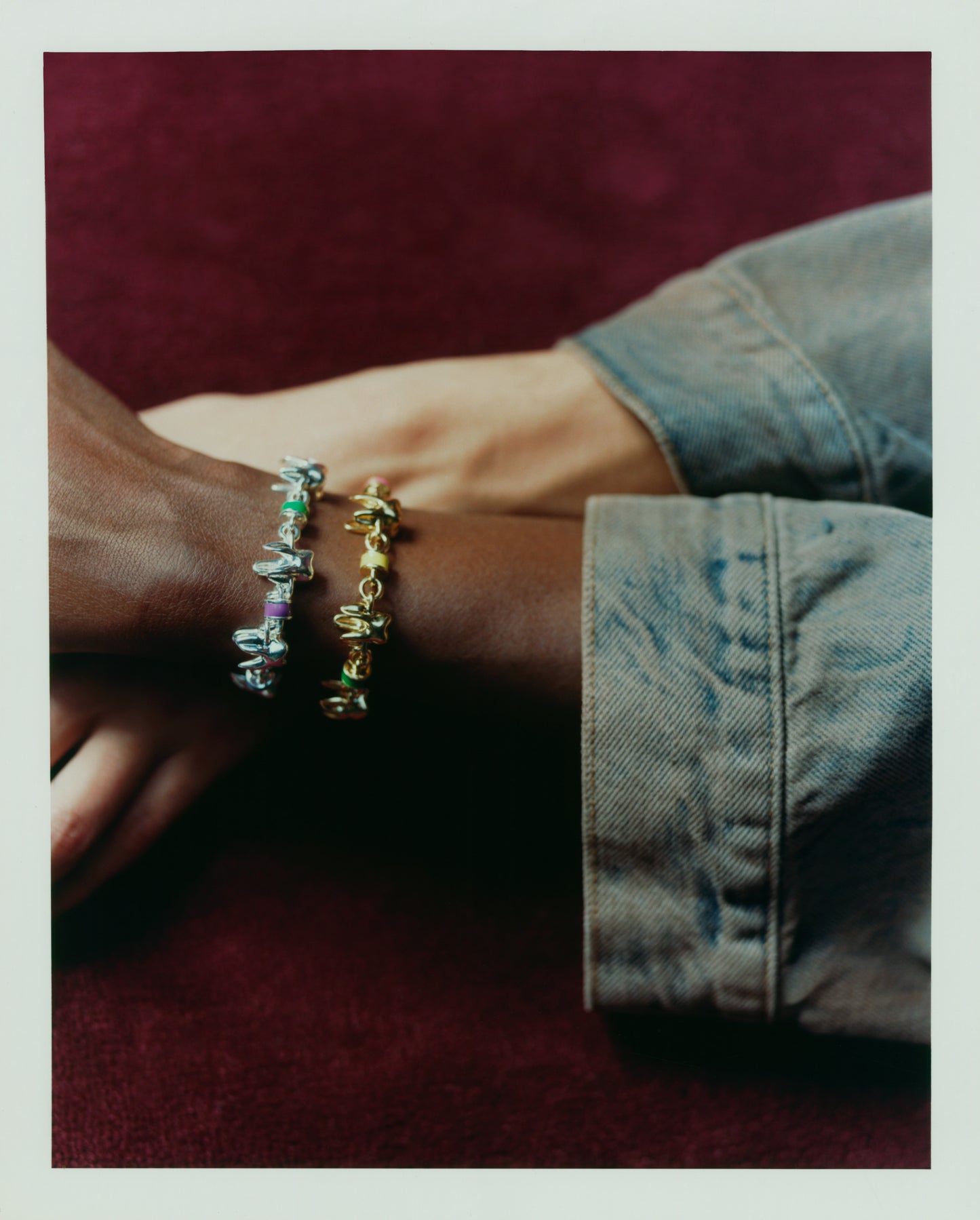 Two ALF Jewelry Molar Bracelets in sterling silver and 18ct gold vermeil with colorful enamel, worn on model's wrists._lifestyle