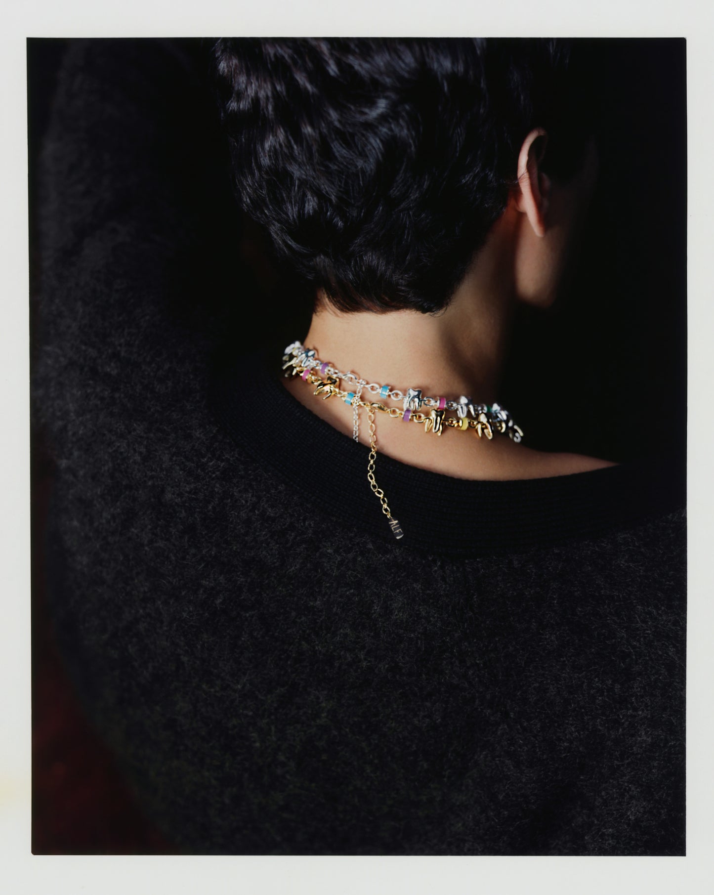 Back view of model wearing ALF Jewelry Molar Necklace with gold chain and colorful enamel accents, handcrafted in France.