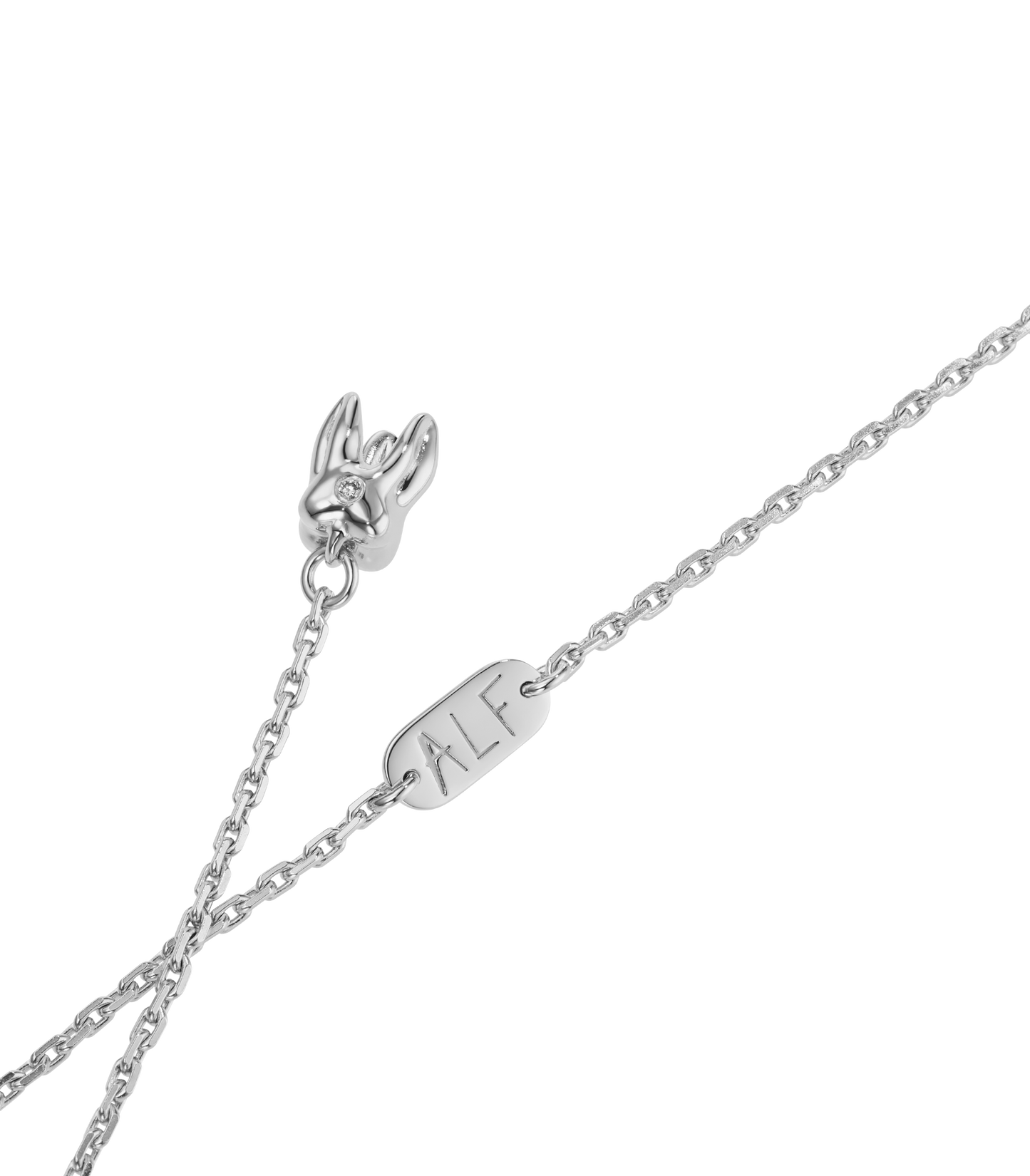 ALF Jewelry Baby Necklace in 1925 sterling silver withruby eyes in deep pink and diamond detail, artisanal luxury piece.