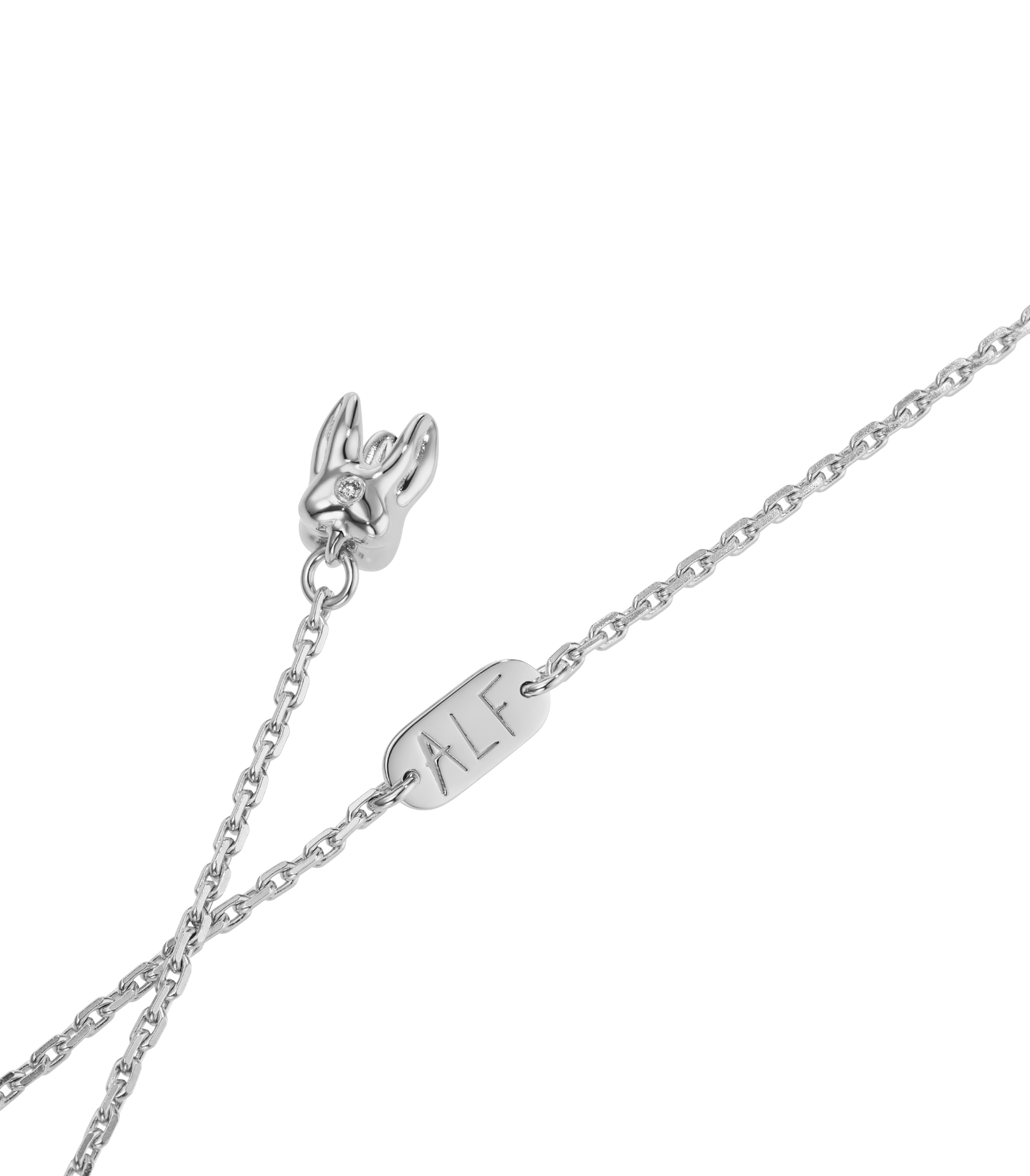 ALF Jewelry Baby Necklace in 1925 sterling silver withruby eyes in deep pink and diamond detail, artisanal luxury piece.